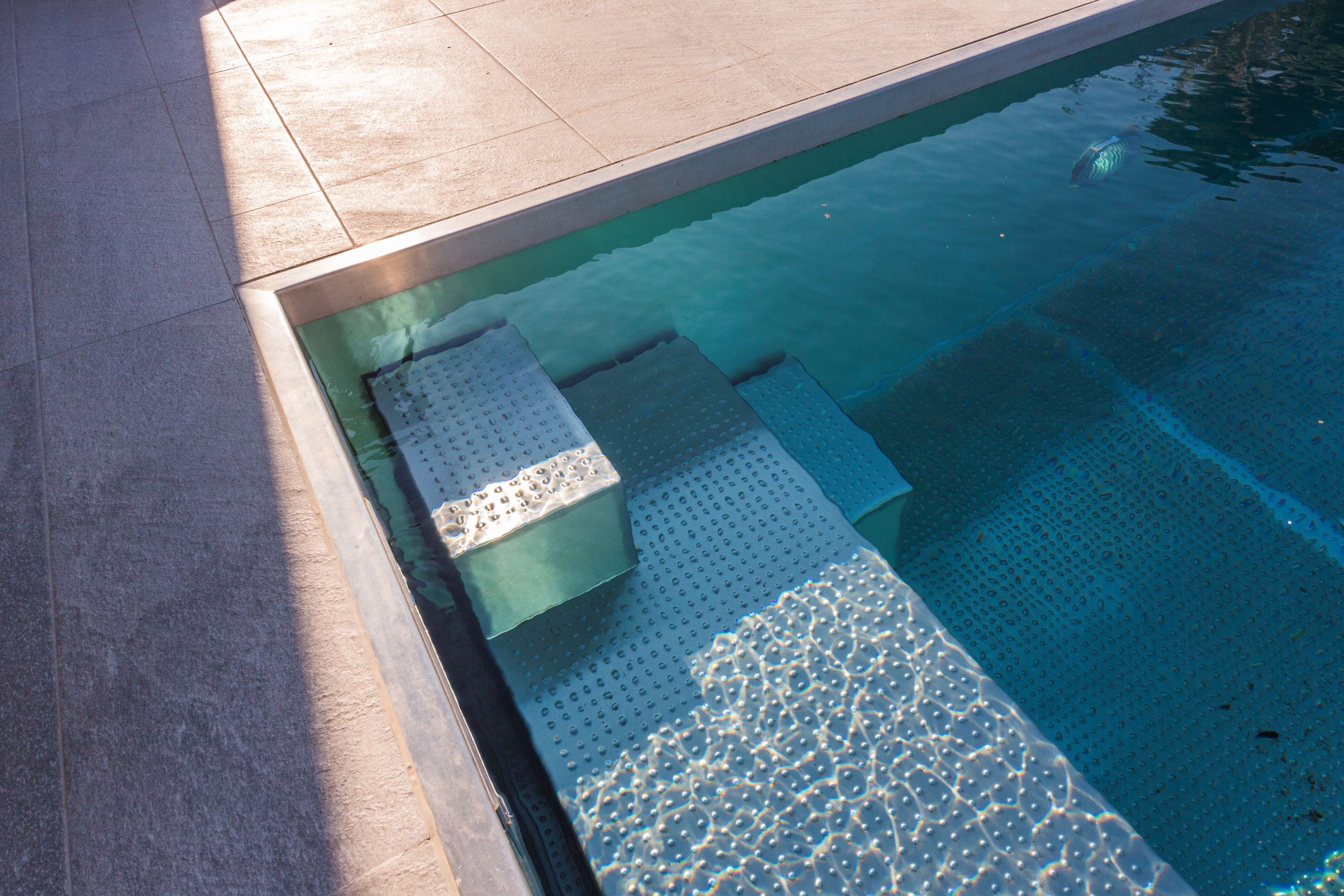Exterior stainless steel pool with slatted cover