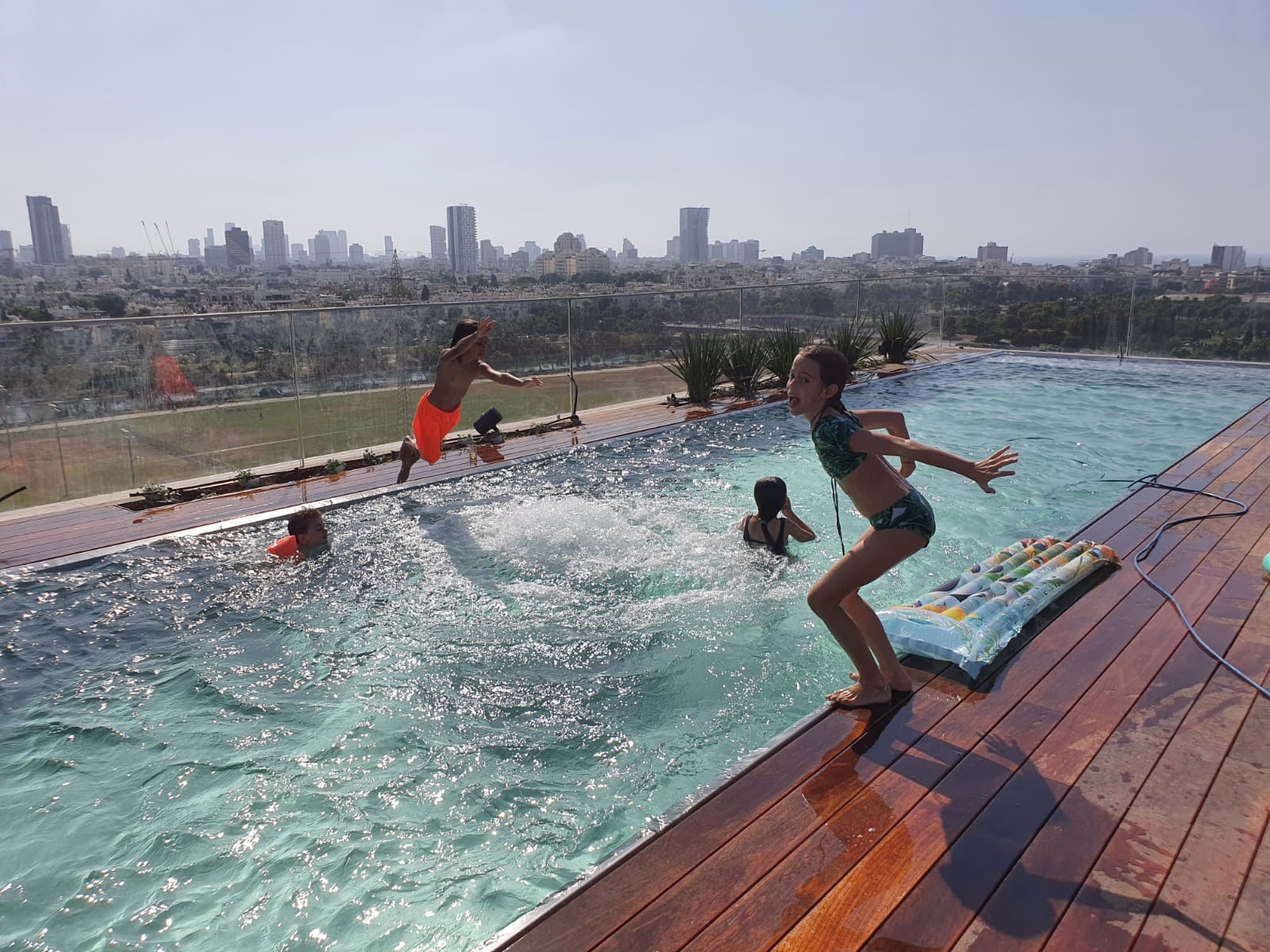 Happy kids in luxury pool by IMAGINOX GROUP
